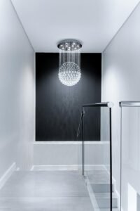 Sleek contemporary hallway featuring a stunning glass chandelier and minimalist design.