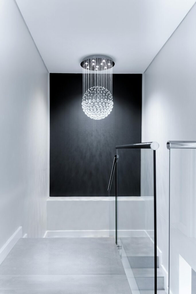 Sleek contemporary hallway featuring a stunning glass chandelier and minimalist design.